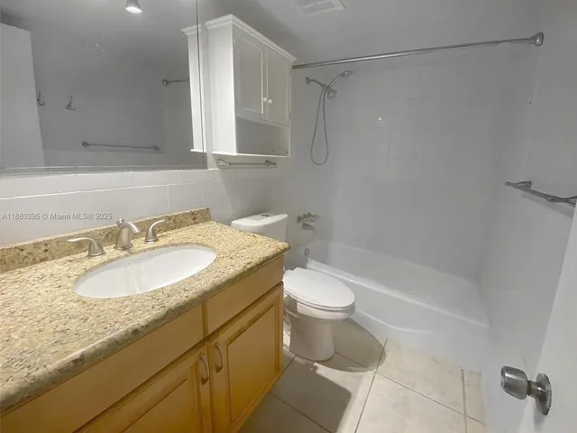 a bathroom with a shower and a glass door