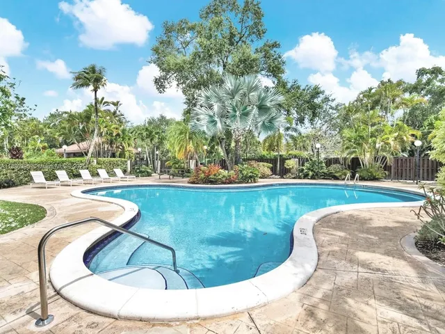 a view of swimming pool with sitting area
