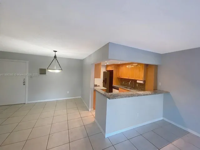 a view of a kitchen with a sink and cabinets