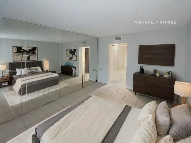 an empty room with a cabinet and mirrors