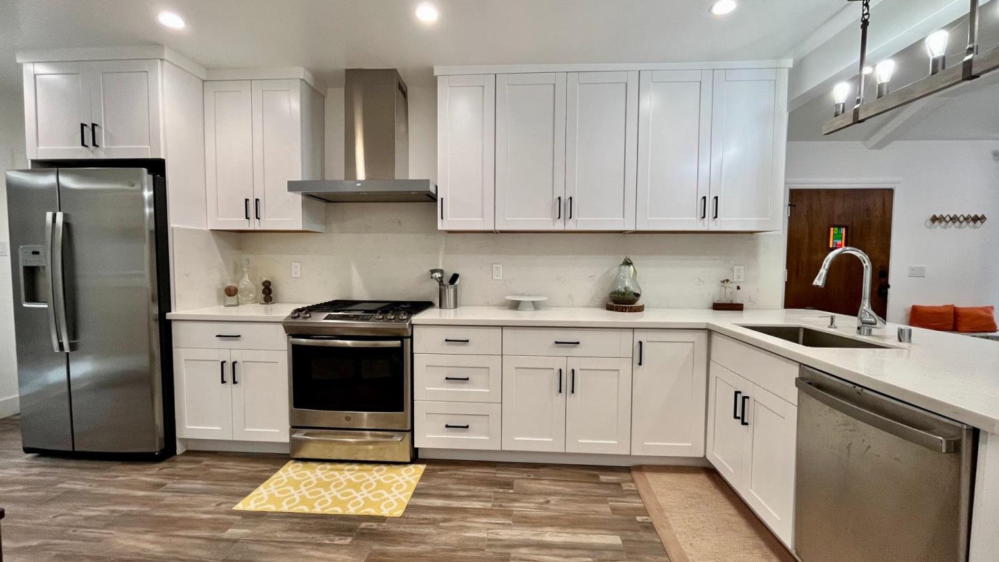 161 Laurel Avenue Millbrae, CA 94030 - Photo 2 of 24 a kitchen with stainless steel appliances granite countertop a refrigerator sink and cabinets