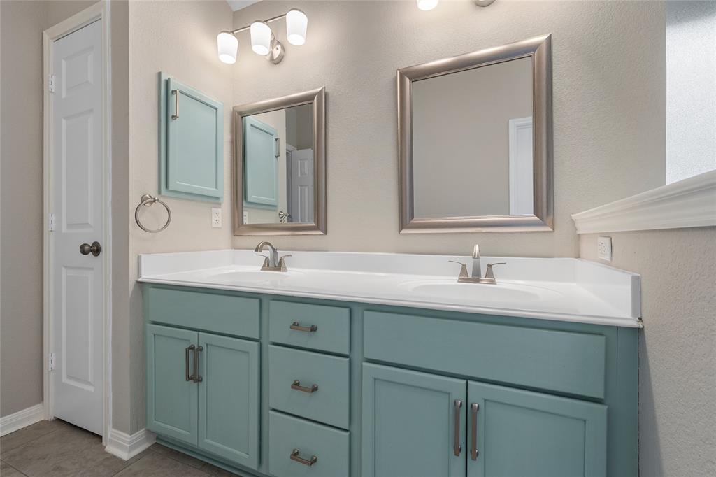 10124 Bunting Drive Waco, TX 76708 - Photo 16 of 18 a bathroom with double sink and a mirror