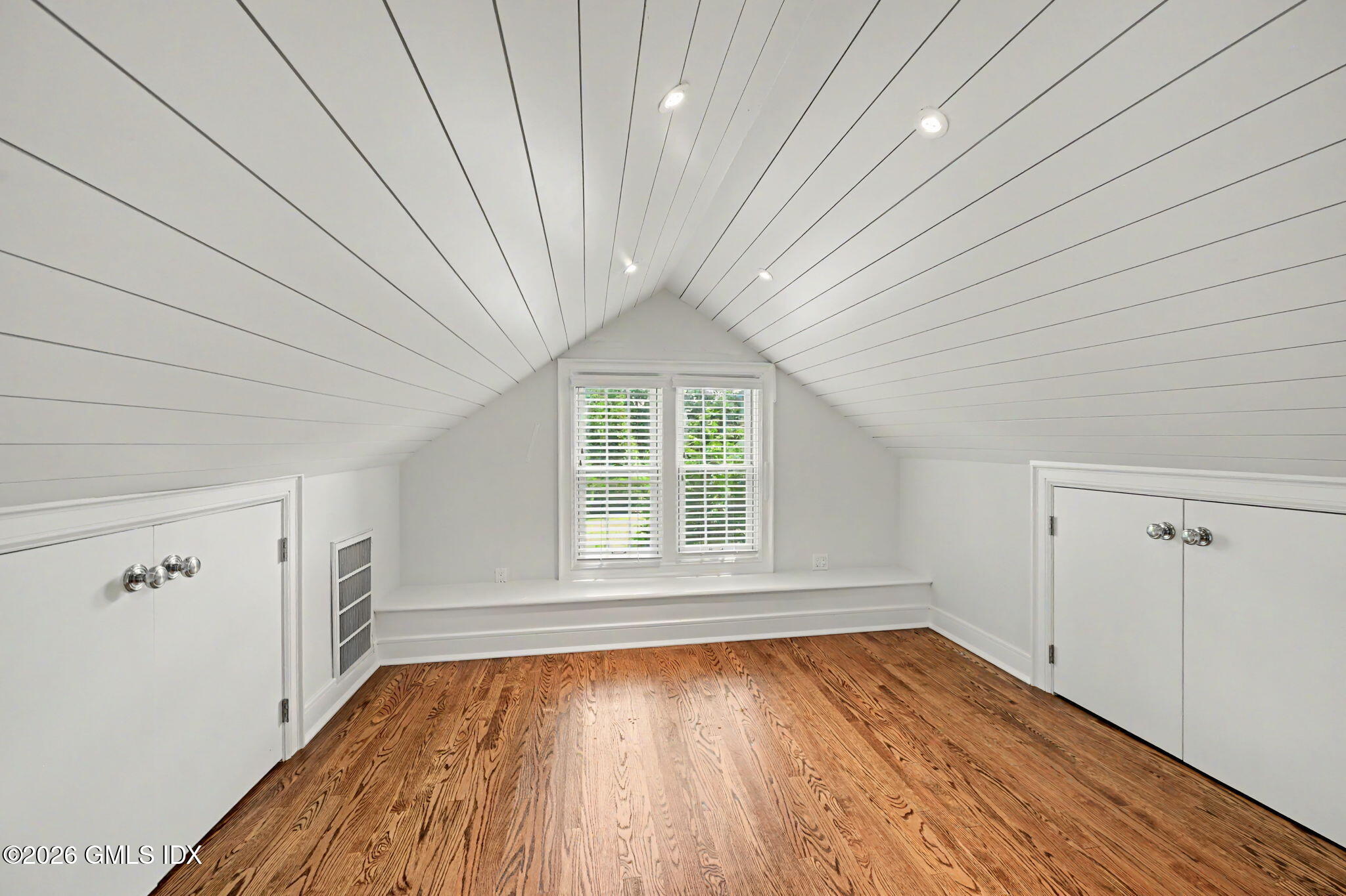 124 Shore Road Old Greenwich, CT 06870 - Photo 21 of 28 an empty room with wooden floor and windows