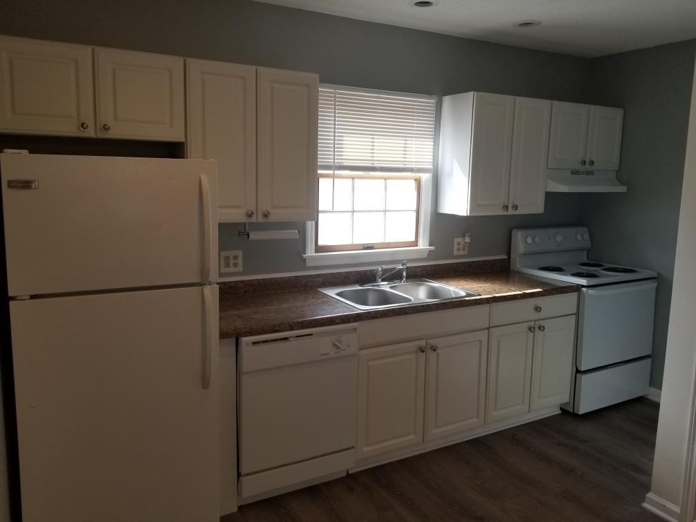 918 6th Street, Unit 3 LaSalle, IL 61301 - Photo 2 of 4 a kitchen with sink a refrigerator and cabinets
