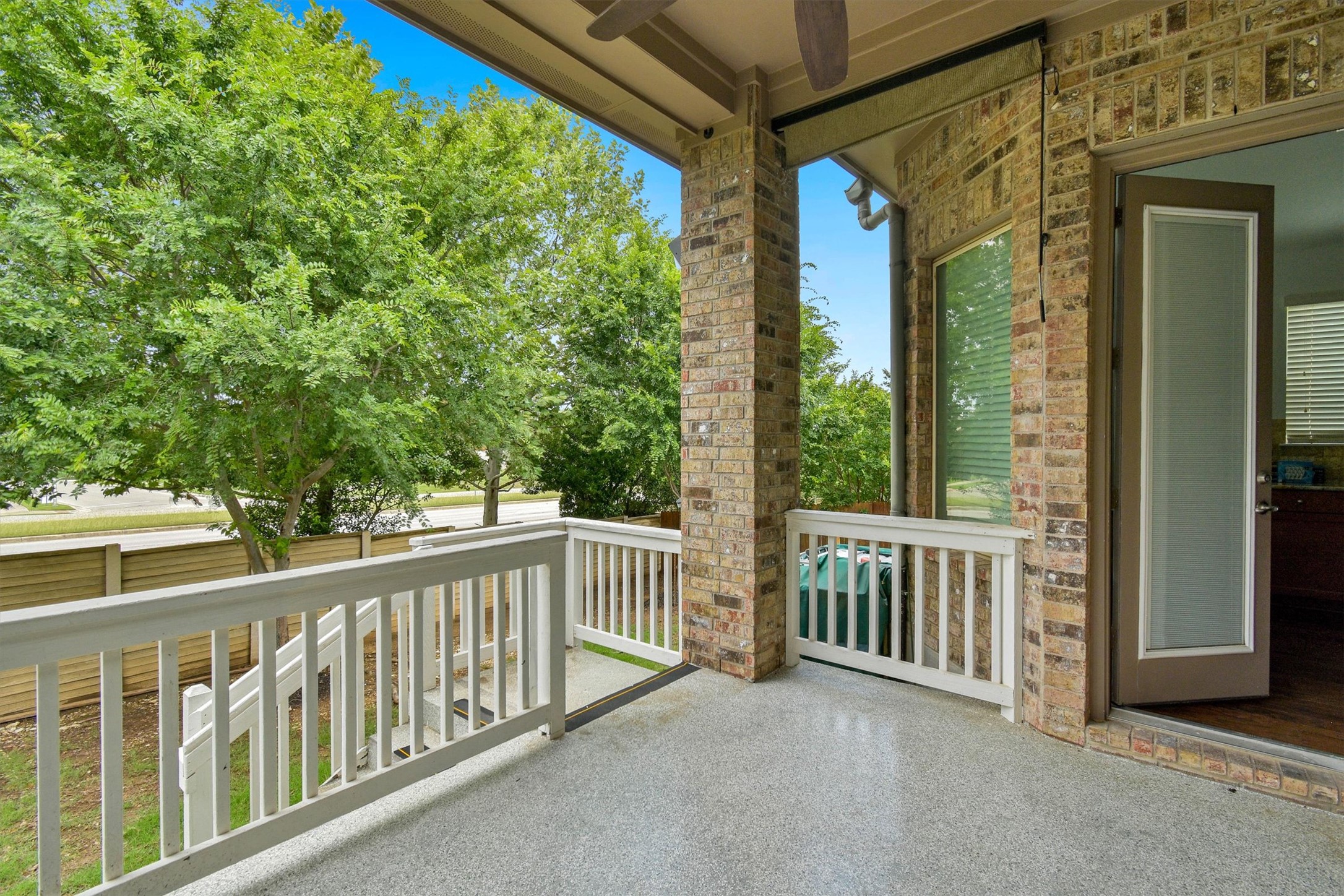 2325 Blended Tree Ranch Drive Leander, TX 78641 - Photo 34 of 35 Enjoy outdoor living on this elevated patio, featuring durable epoxy flooring and scenic views.