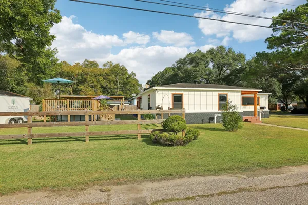 a front view of a house with a garden