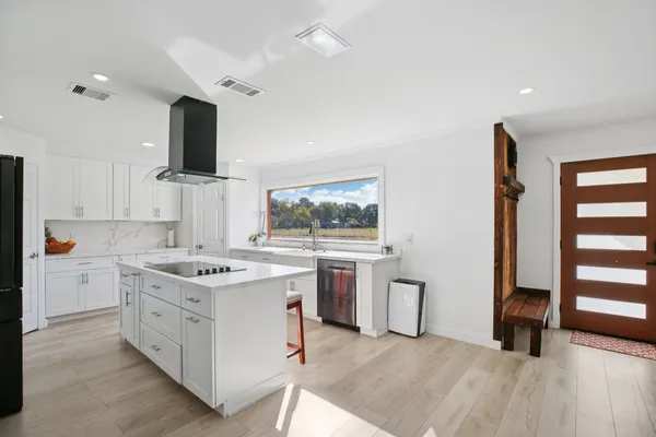 a kitchen with a sink stove and cabinets