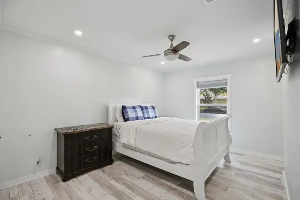 a bedroom with a bed and a chandelier