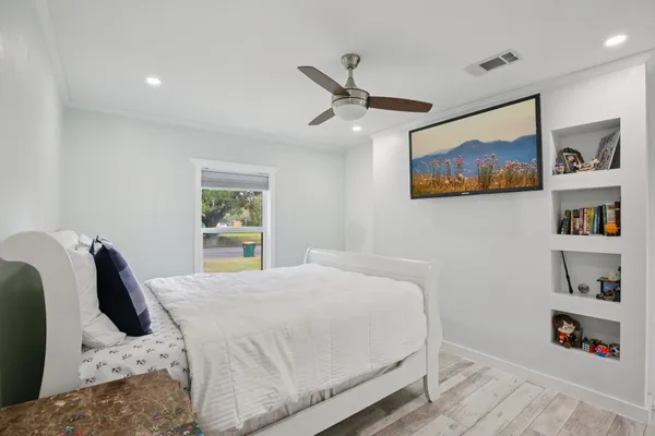 a bedroom with a bed and wall painting