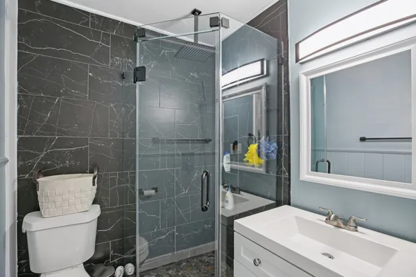 a bathroom with a sink toilet and shower