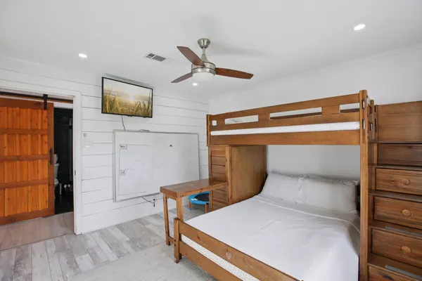 a bedroom with a bed and a television