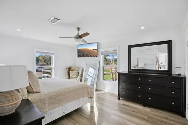 a bedroom with a bed window and a dresser