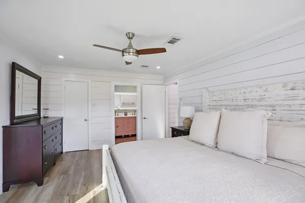 a bedroom with a large bed and a chandelier