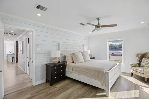 a bedroom with a bed and a chandelier