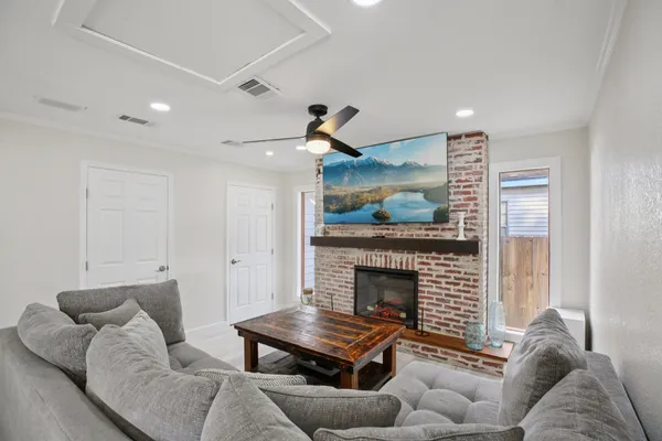 a living room with furniture and a fireplace