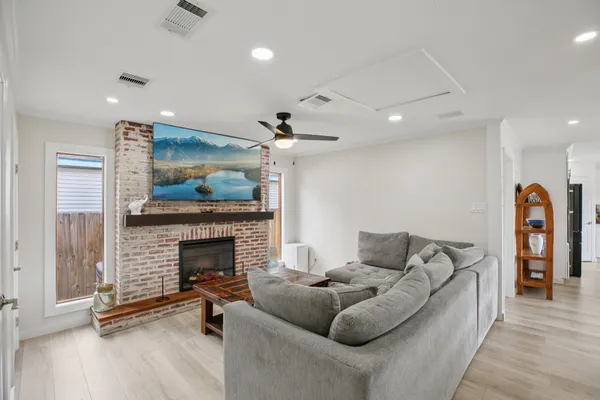 a living room with furniture and a fireplace