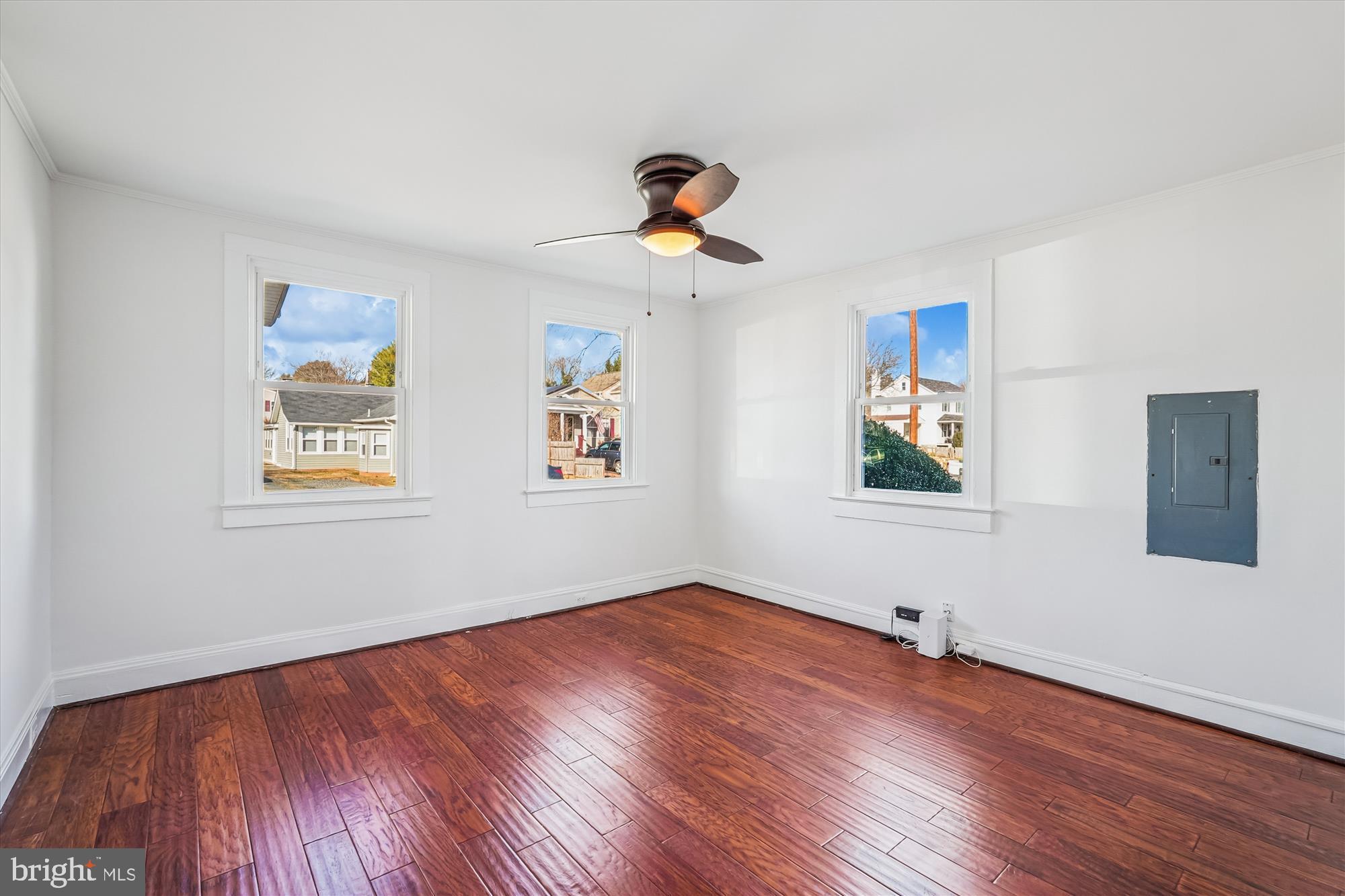 104 Pershing Avenue Northwest Leesburg, VA 20176 - Photo 17 of 36 a view of a room with wooden floor ceiling fan and windows