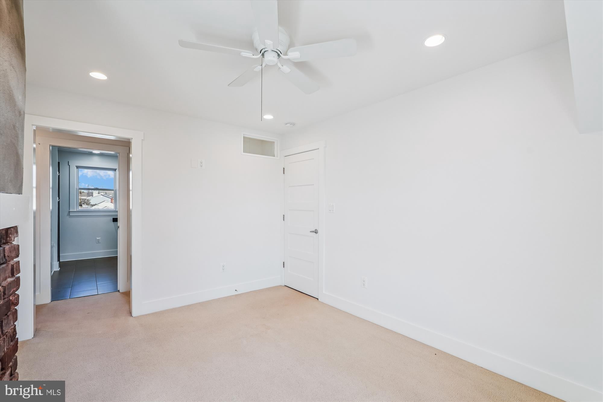 104 Pershing Avenue Northwest Leesburg, VA 20176 - Photo 25 of 36 an empty room with a ceiling fan and a bathroom
