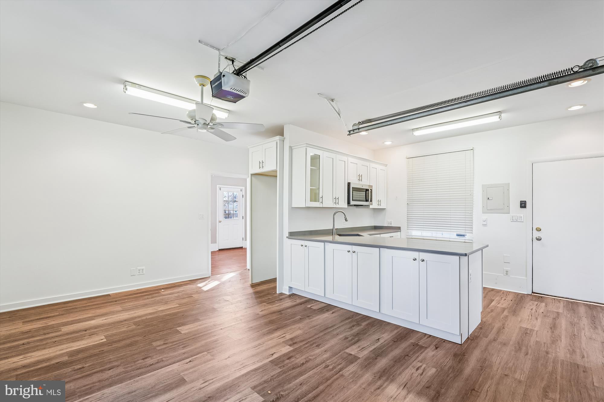 104 Pershing Avenue Northwest Leesburg, VA 20176 - Photo 32 of 36 a large kitchen with a wooden floor and stainless steel appliances