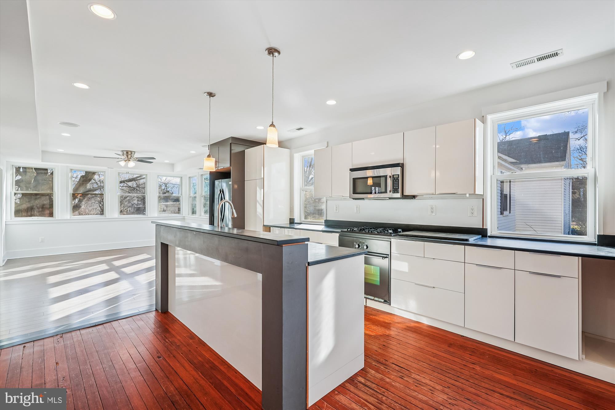 104 Pershing Avenue Northwest Leesburg, VA 20176 - Photo 8 of 36 a kitchen with stainless steel appliances granite countertop wooden floors and white cabinets