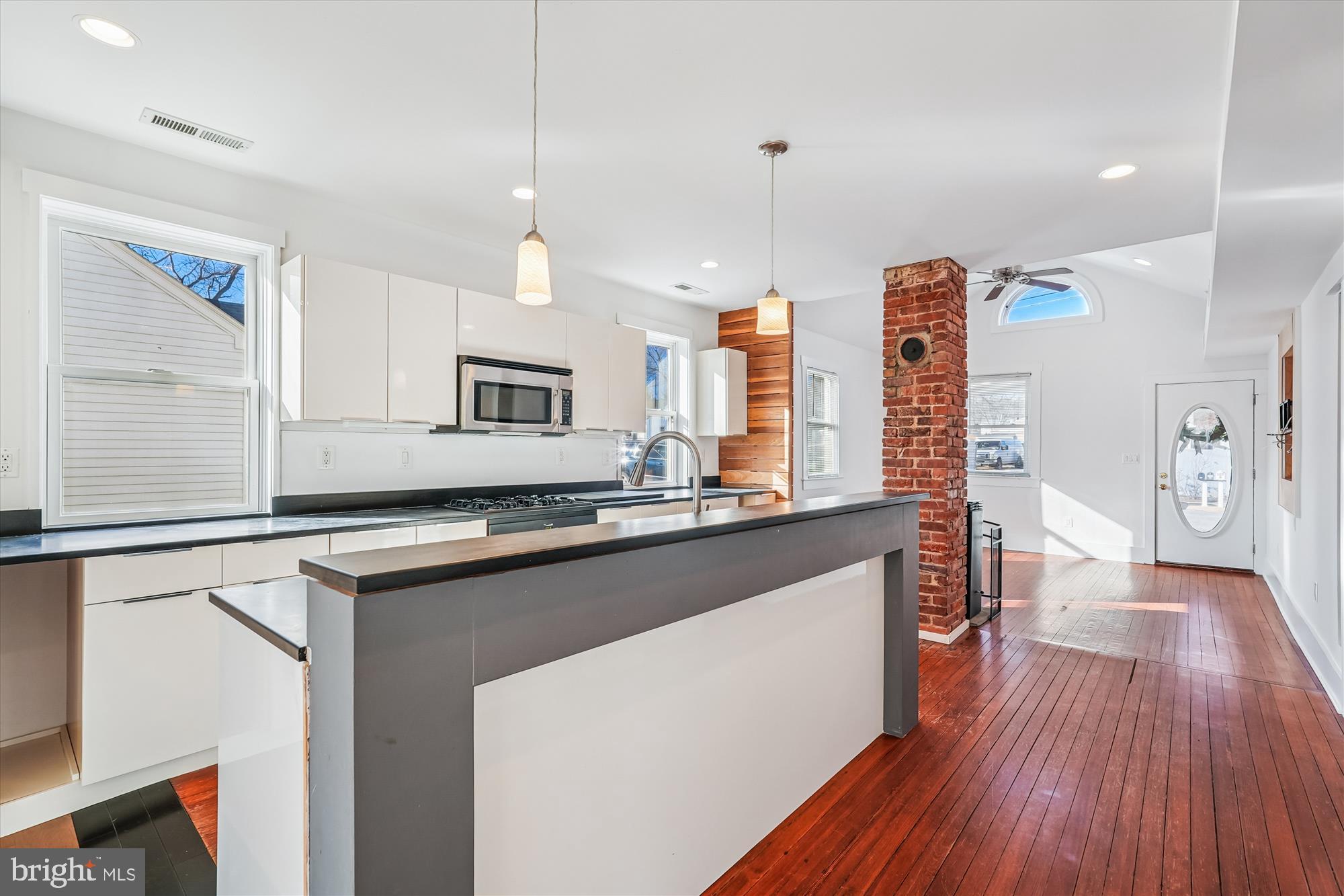 104 Pershing Avenue Northwest Leesburg, VA 20176 - Photo 10 of 36 a kitchen with stainless steel appliances granite countertop a sink cabinets and wooden floor