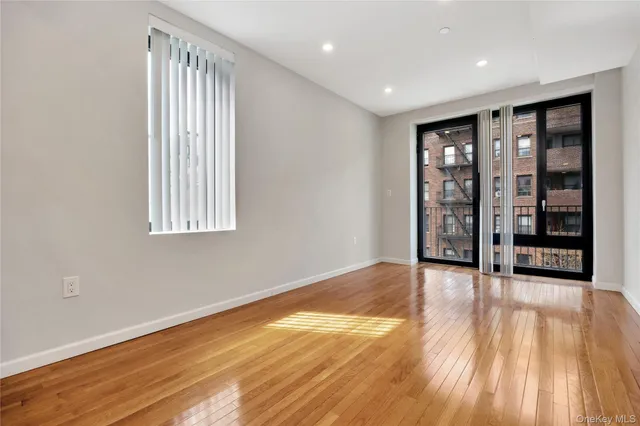 an empty room with large windows