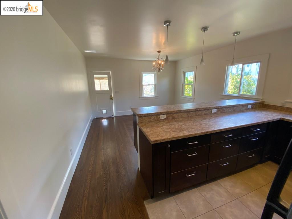 2124 Fifth Street Berkeley, CA 94710 - Photo 15 of 25 a view of a kitchen island a sink wooden floor and a window