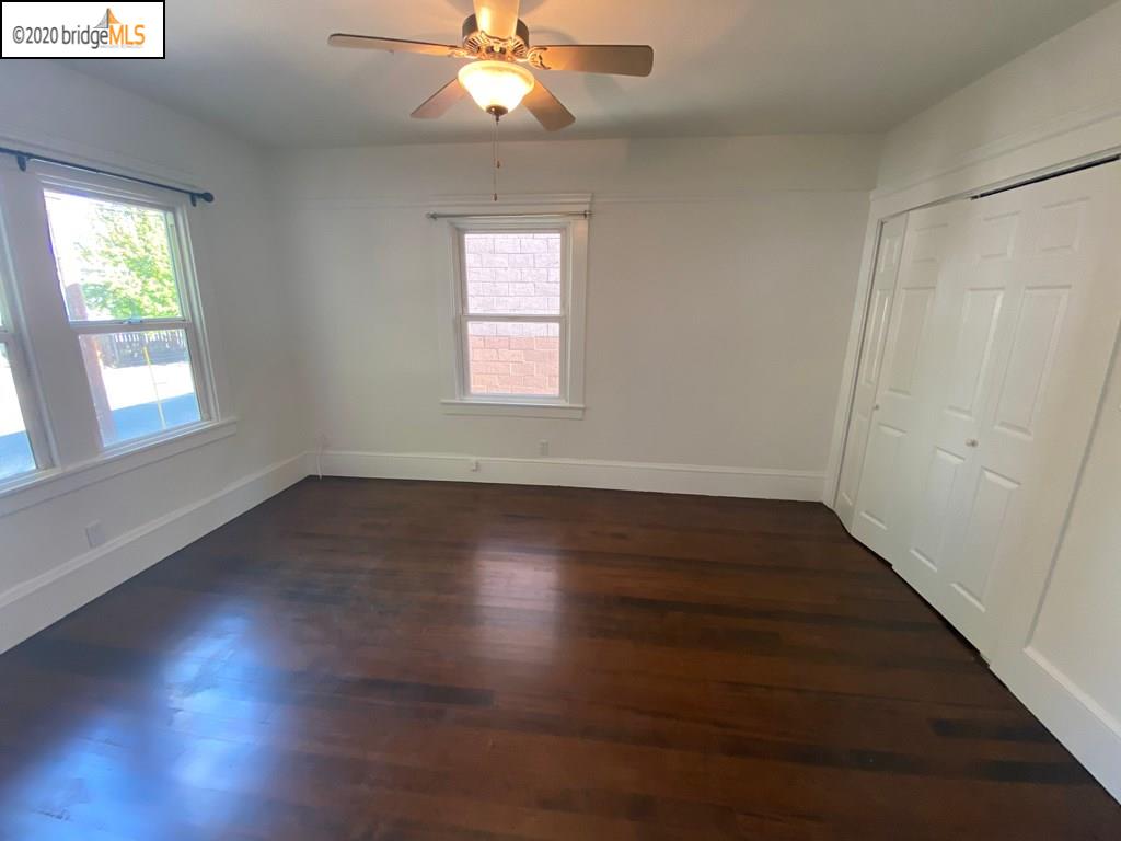 2124 Fifth Street Berkeley, CA 94710 - Photo 5 of 25 an empty room with wooden floor fan and windows