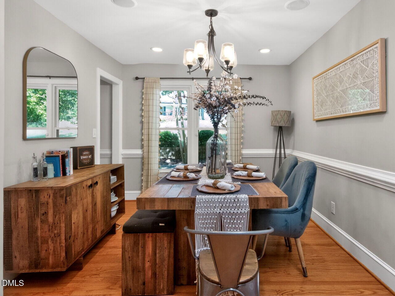 6004 Tarnhour Court Raleigh, NC 27612 - Photo 13 of 44 a view of a dining room with furniture a chandelier and wooden floor