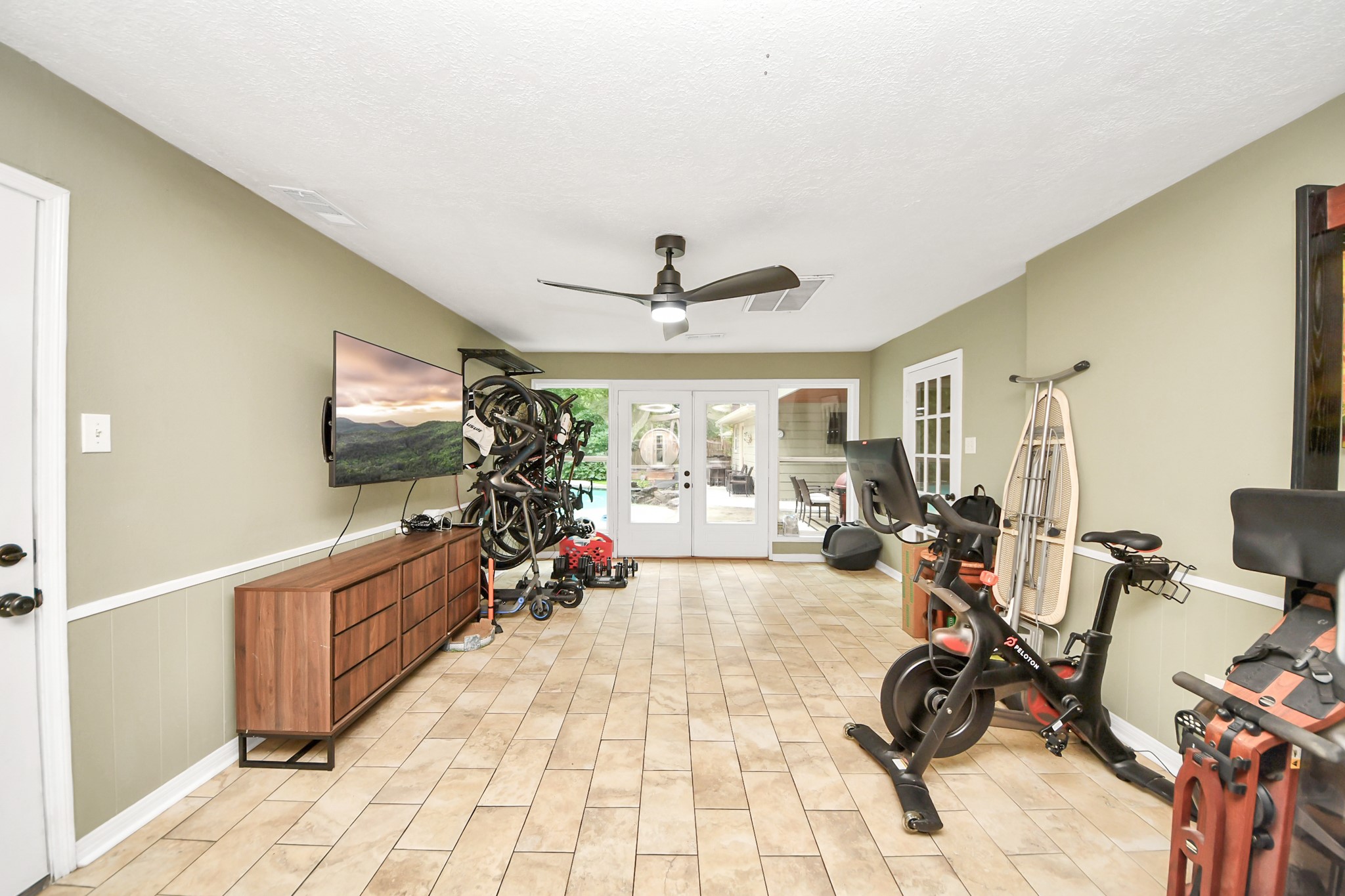 6403 Craigway Road Spring, TX 77389 - Photo 18 of 39 Dedicated home gym or game room with built-in bike rack. French door access to backyard