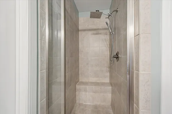 a bathroom with a glass shower door