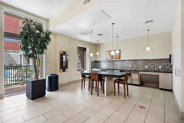 a living room with furniture a air conditioner and potted plant