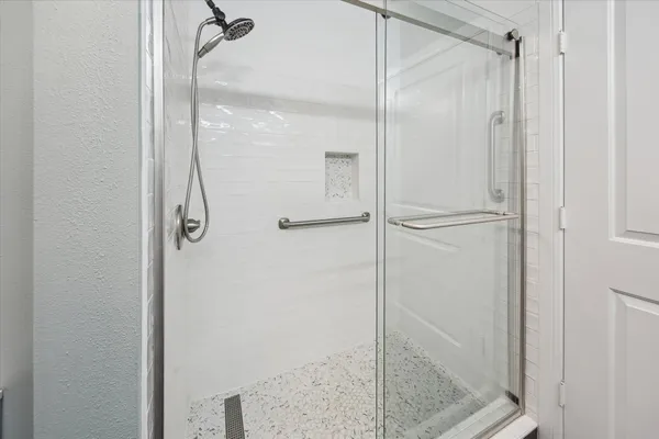 a bathroom with a glass shower door