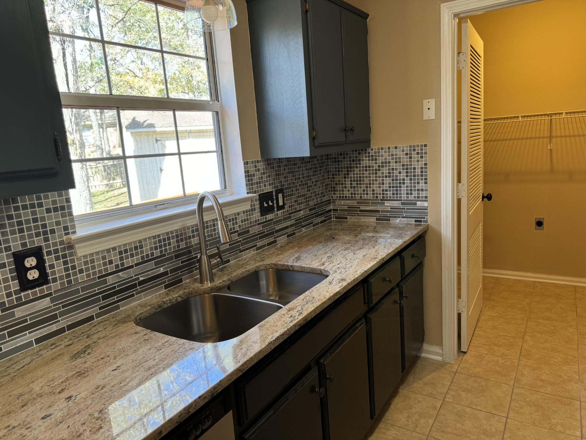 a kitchen with a sink and a window