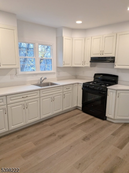 173 Highway 46, Unit 3 Mine Hill, NJ 07803 - Photo 4 of 11 a kitchen with white cabinets appliances and a window