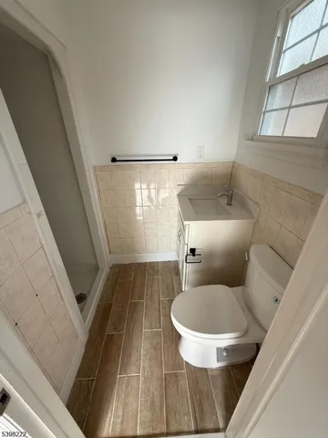 a bathroom with a toilet and a shower