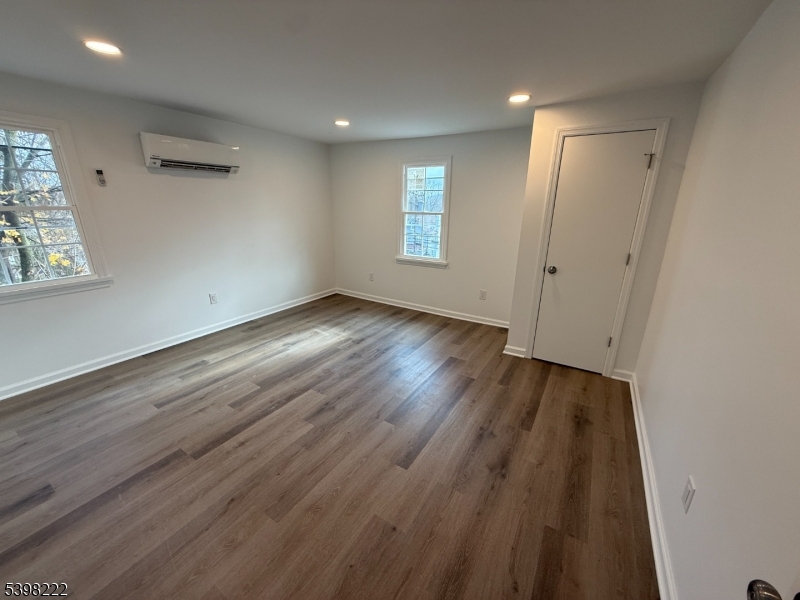 173 Highway 46, Unit 3 Mine Hill, NJ 07803 - Photo 7 of 11 an empty room with wooden floor and windows