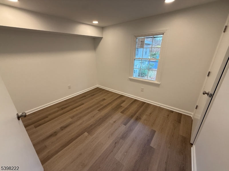 173 Highway 46, Unit 3 Mine Hill, NJ 07803 - Photo 9 of 11 an empty room with wooden floor and windows
