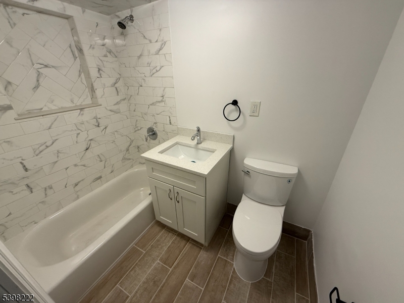 173 Highway 46, Unit 3 Mine Hill, NJ 07803 - Photo 10 of 11 a bathroom with a toilet sink and mirror