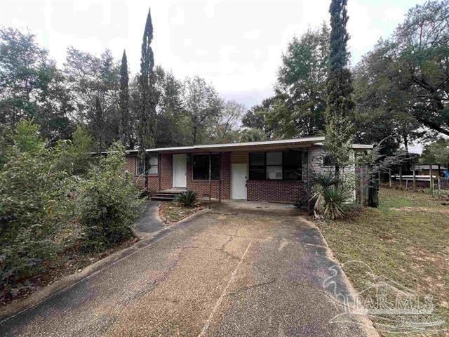 5733 Orange Street Milton, FL 32570 - Photo 1 of 32 a view of a house with backyard and trees in the background