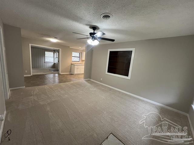 5733 Orange Street Milton, FL 32570 - Photo 13 of 32 a view of a livingroom with a ceiling fan and a window