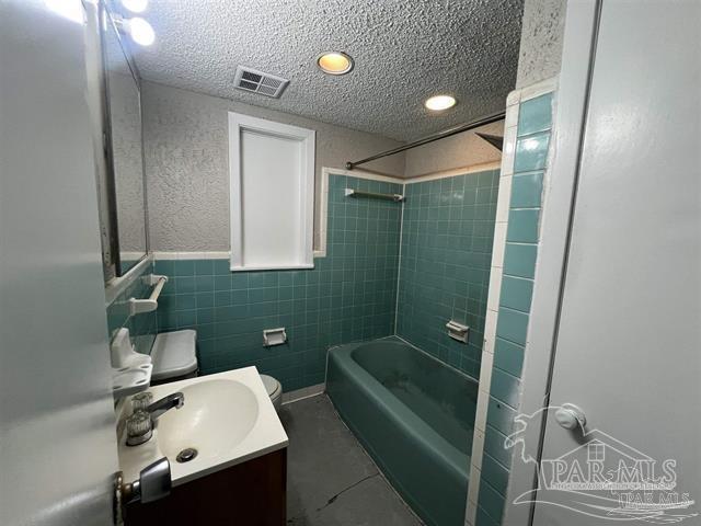 5733 Orange Street Milton, FL 32570 - Photo 22 of 32 a bathroom with a toilet a sink and mirror