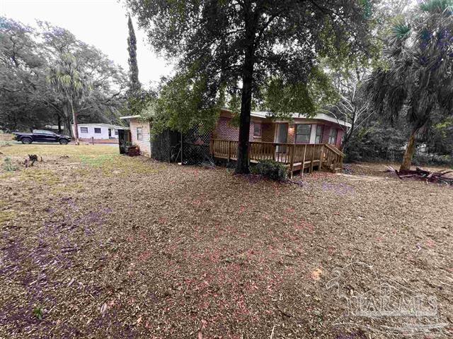5733 Orange Street Milton, FL 32570 - Photo 28 of 32 a view of a house with a yard