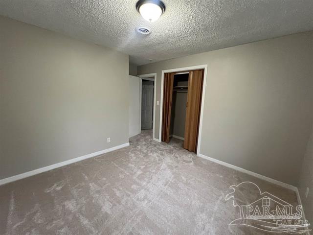 5733 Orange Street Milton, FL 32570 - Photo 31 of 32 an empty room with closet and wooden floor
