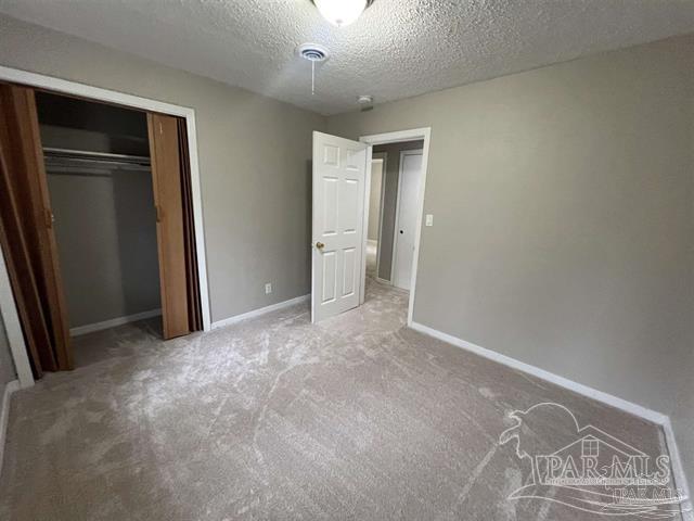 5733 Orange Street Milton, FL 32570 - Photo 4 of 32 an empty room with closet and windows