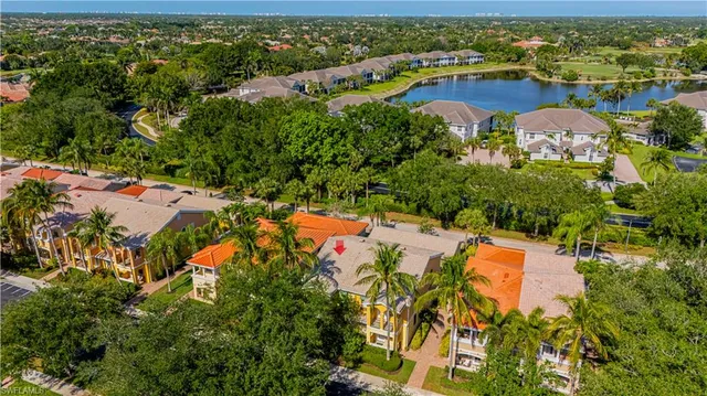an aerial view of residential houses with outdoor space and parking