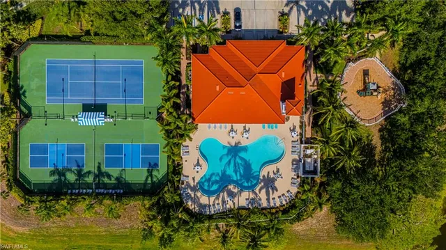 an aerial view of a house with a yard and potted plants