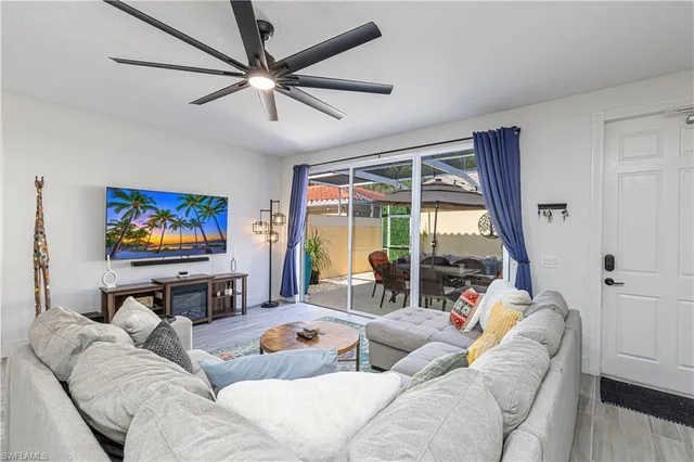 a living room with furniture a large window and a flat screen tv