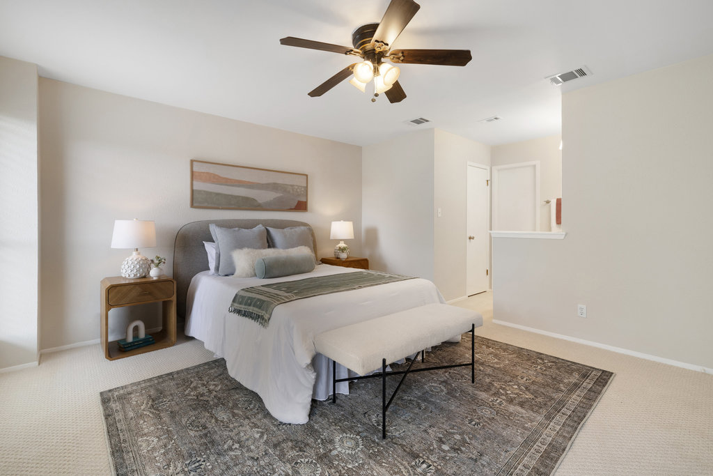 7812 Turquoise Trail Austin, TX 78749 - Photo 19 of 28 a bedroom with a bed and a chandelier