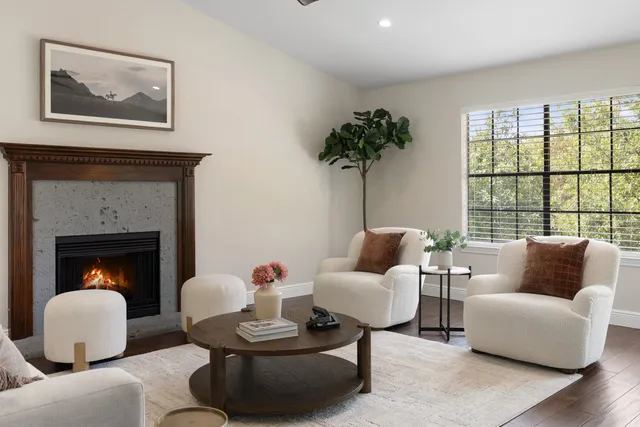 a living room with furniture and a large mirror